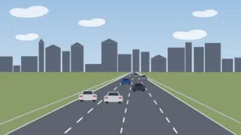 Breite Stadtautobahn mit vielen Autos, im Hintergrund eine dichte Reihe von Gebäuden