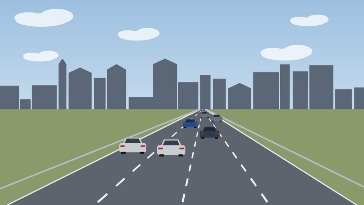 Breite Stadtautobahn mit vielen Autos, im Hintergrund eine dichte Reihe von Gebäuden
