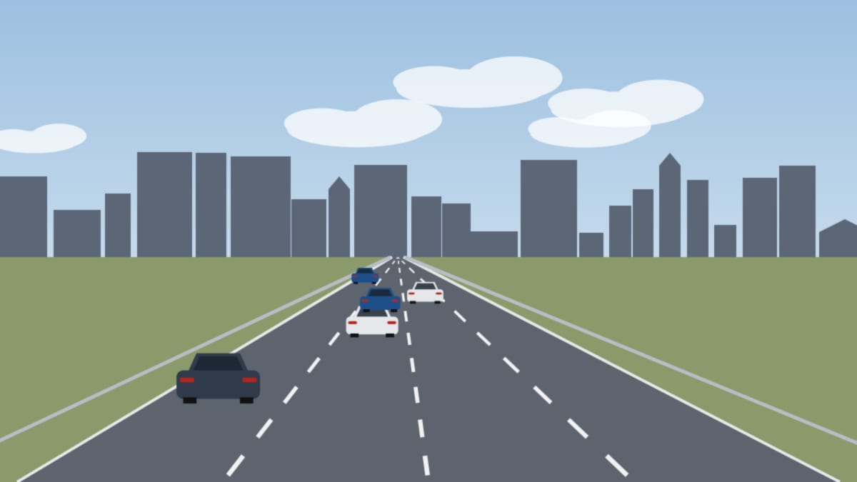 Stadtautobahn mit mehreren Fahrstreifen vor einer Reihe von Wohn- und Bürogebäuden