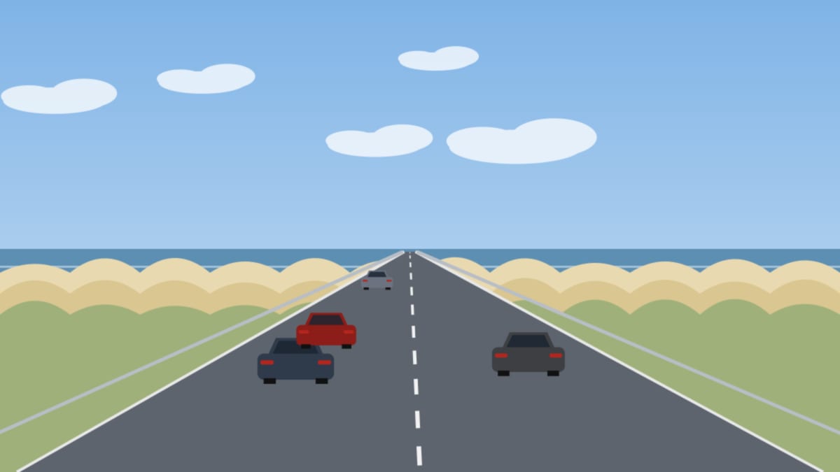 Küstenstraße zwischen Dünen und Meer unter blauem Sommerhimmel mit einzelnen Autos