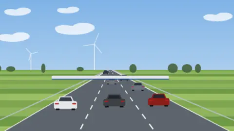 Dichter Verkehr auf einer Autobahn vor einer flachen Kontrollüberdachung, Felder und Bäume am Horizont