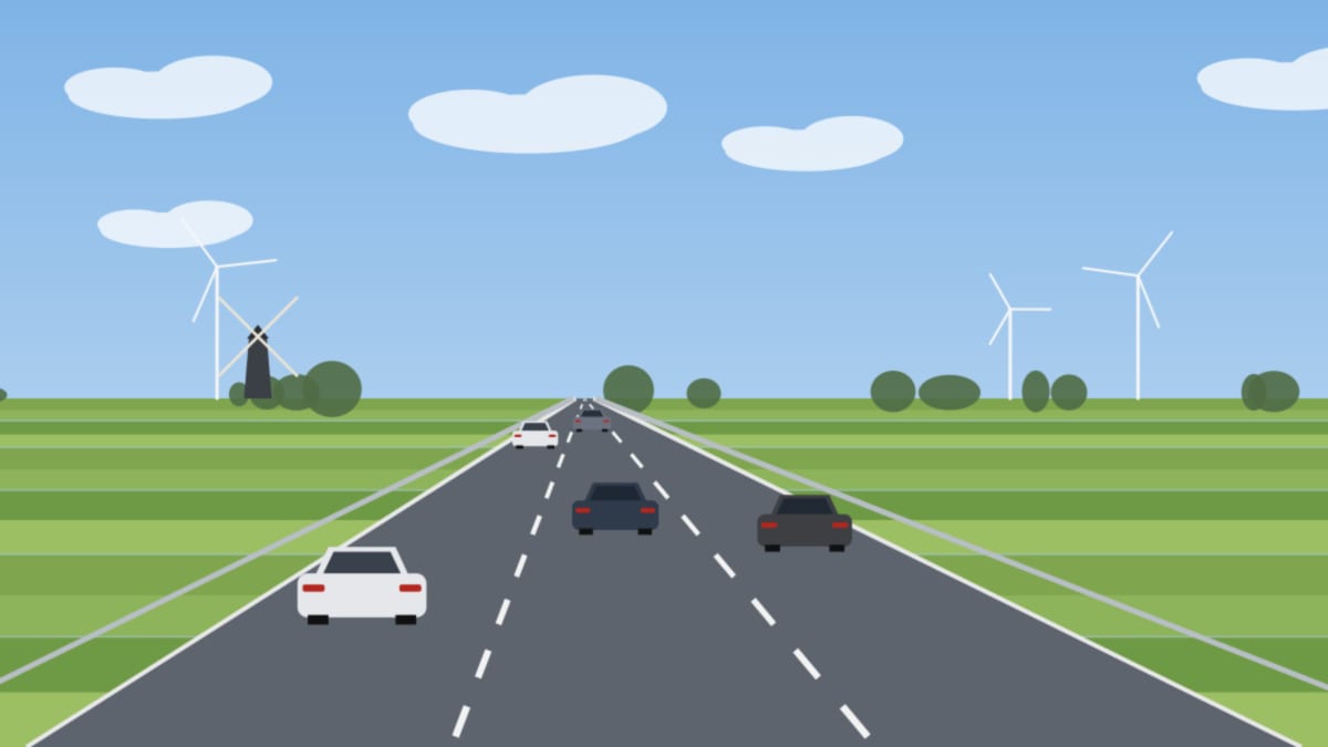 Dreispurige Autobahn durch flaches Polderland mit Windrädern am Horizont, mehrere Autos von hinten